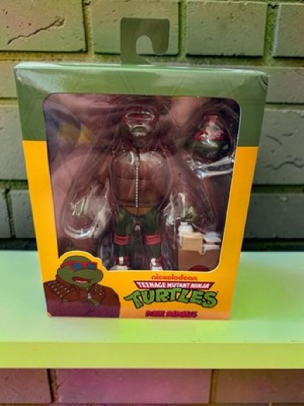 Neca TMNT Punk Raphael Action Figure, Green/Brown/Red w/ Heads Hands Bag